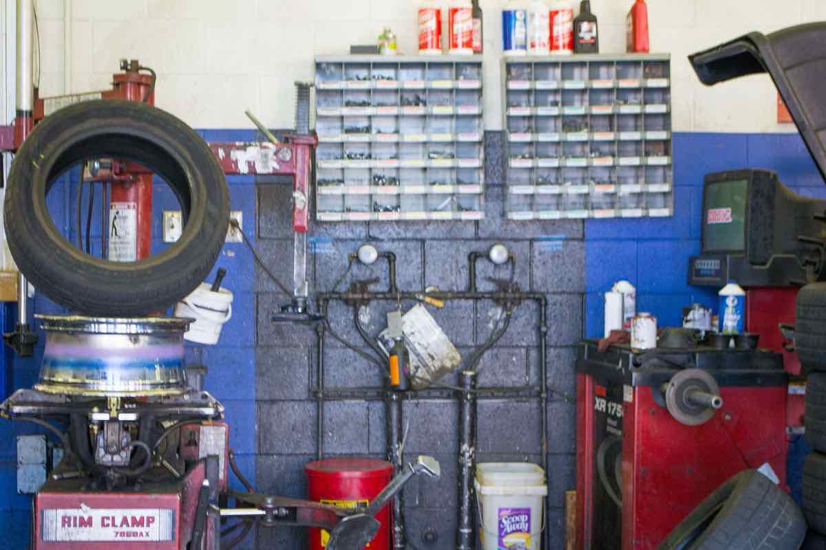 Inside a tire shop: tire changer, wheel balancer, tools and parts bins